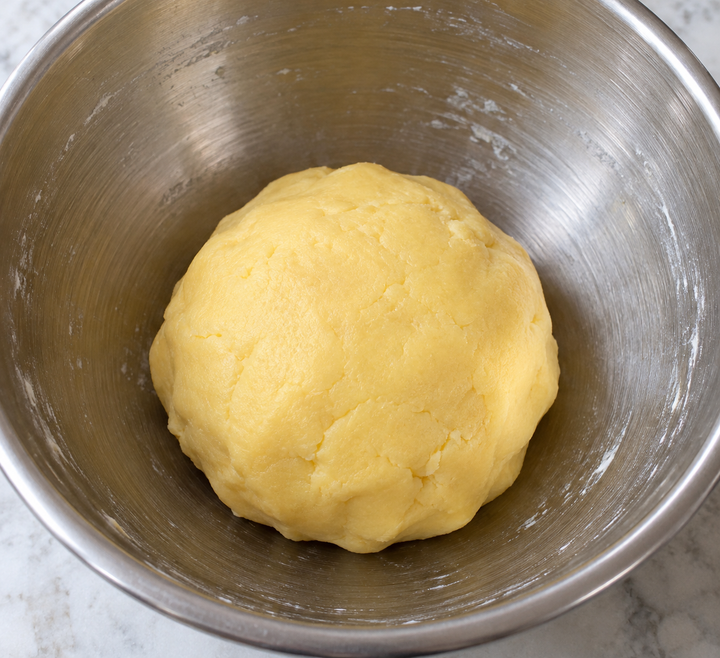 Rub butter and sugar together, then add yolks and flour and knead briefly