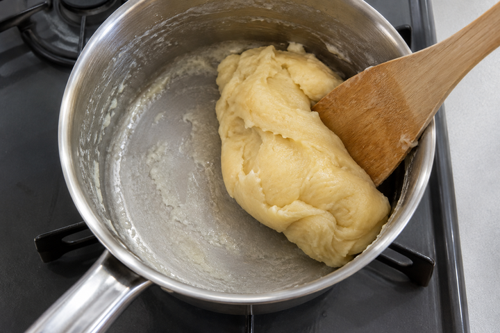 Boil milk and butter, add flour and dry the dough
