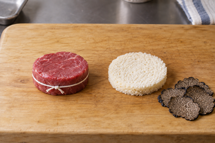 Temper and tie the beef, cut the bread and slice the truffle