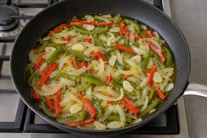 Soften the onion and peppers in oil