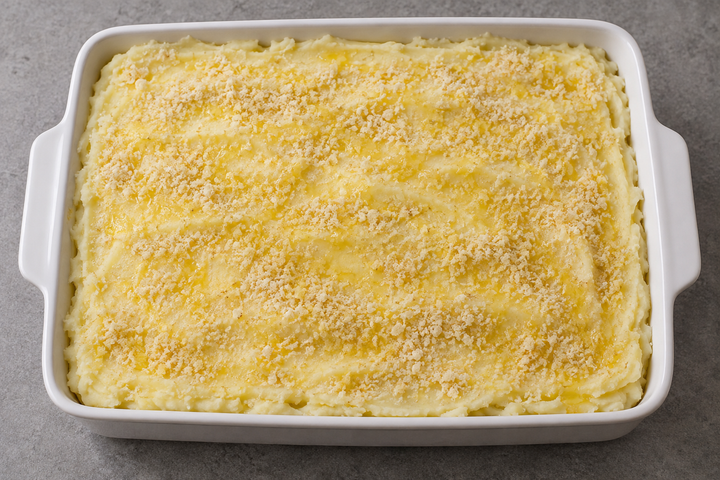 Layer the meat and purée; add breadcrumbs and butter