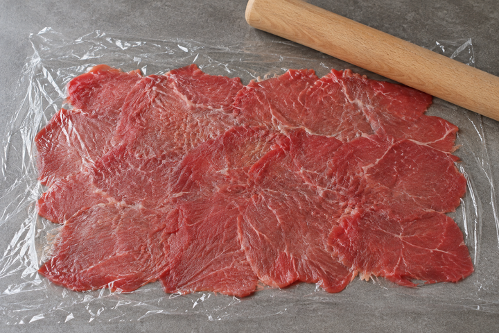 牛肉を薄くたたき伸ばす